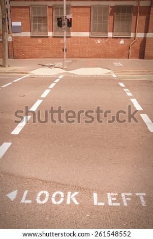 Look Left - pedestrian street sign in Brisbane, Australia. Cross processed color tone - retro filtered style.