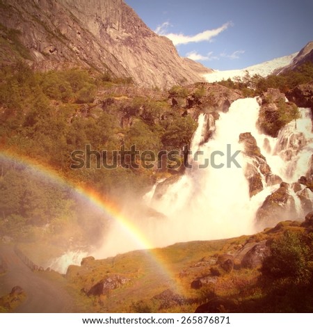 Waterfall in Norway, Jostedalsbreen National Park. Vintage style photo color.