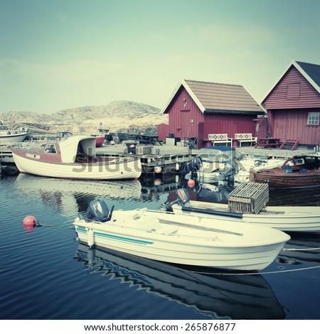 Norway fishing harbor at Skjernoya island. Vintage style photo color.
