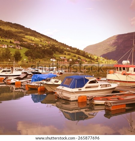 Norway, Sogn of Fjordane county. Fishing harbor, Nordfjord in Olden. Vintage style photo color.