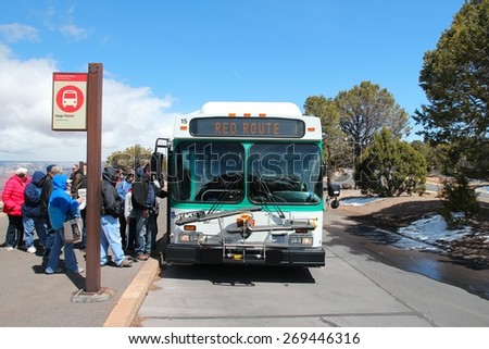 GRAND CANYON, USA - APRIL 3, 2014: People ride the Hermit Road shuttle bus in Grand Canyon National Park in Arizona. 4.56 million tourists visited Grand Canyon in 2013.