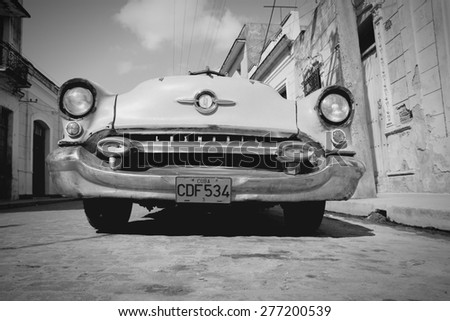 CAMAGUEY, CUBA - FEBRUARY 17, 2011: Vintage car parked in Camaguey, Cuba. Cuba has one of the lowest car-per-capita rates (38 per 1000 people in 2008).
