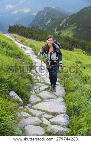 Poland - Tatra National Park in Tatra Mountains. Woman tourist hikes the trail to Swistowa Czuba.