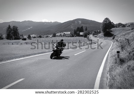 Motorbiking in Austrian Alps. Alpine landscape in Upper Austria. Road to Pass Gschutt. Black and white tone.