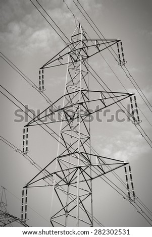High voltage electricity pylon in Switzerland. Power grid. Black and white tone.