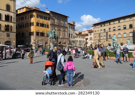FLORENCE, ITALY - APRIL 30, 2015: People visit Old Town square Piazza della Signoria in Florence, Italy. Italy is visited by 47.7 million tourists a year (2013).