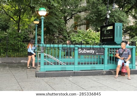 NEW YORK, USA - JULY 1, 2013: People enter subway station in New York. With 1.67 billion annual rides, New York City Subway is the 7th busiest metro system in the world.