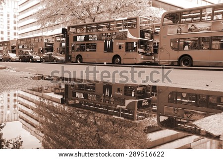 LONDON, UK - MAY 15, 2012: People ride London Buses in London. As of 2012, LB serves 19,000 bus stops with a fleet of 8000 buses. On a weekday 6 million rides are served.