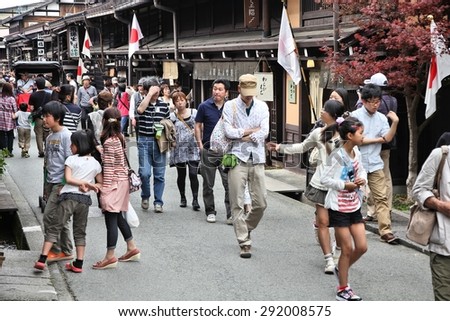 TAKAYAMA, JAPAN - APRIL 29, 2012: People visit the Old Town in Takayama, Japan. Takayama is among top 25 tourism destinations in Japan according to Japan-Guide.com.