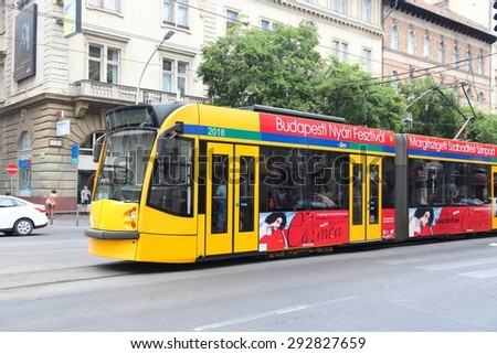 BUDAPEST, HUNGARY - JUNE 19, 2014: People ride tram in Budapest. It is part of BKK public transport system which serves 1.4 billion annual rides (2011).