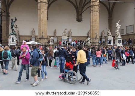 FLORENCE, ITALY - APRIL 30, 2015: People visit famous public sculpture display in Loggia dei Lanzi, Florence, Italy. Italy is visited by 47.7 million tourists a year (2013).