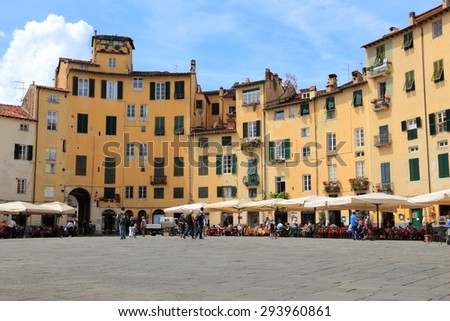 FLORENCE, ITALY - APRIL 29, 2015: People visit Old Town square (Piazza Anfiteatro or Amphitheater Square) in Lucca, Italy. Italy is visited by 47.7 million tourists a year (2013).
