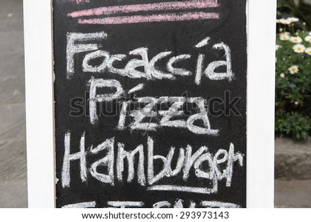 Italian cuisine - restaurant blackboard menu with focaccia, pizza and hamburger.