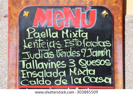 Restaurant menu with typical Spanish food - outdoor bar in Madrid, Spain. Generic dish names.