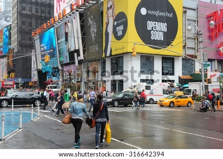 NEW YORK, USA - JUNE 10, 2013: People visit rainy Times Square, NY. Times Square is one of most recognized places in the world. More than 300,000 people pass through Times Square daily.