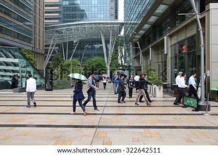 TOKYO, JAPAN - MAY 9, 2012: People visit Tokyo Midtown complex. The district project was completed in 2007 at a cost of 3 billion USD.