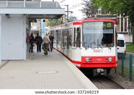 DORTMUND, GERMANY - JULY 16, 2012: People ride city tram in Dortmund, Germany. Dortmund light rail network serves 130 million annual rides (2007).