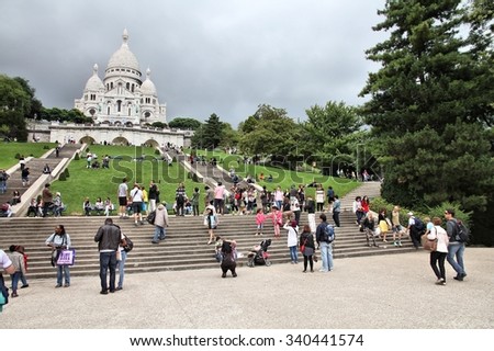 PARIS, FRANCE - JULY 22, 2011: Tourists visit Montmartre district in Paris, France. Paris is the most visited city in the world with 15.6 million international arrivals in 2011.