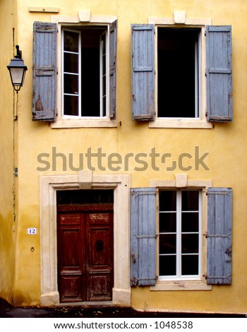 Old Yellow House With Three Windows With Blue Shutters, A Door And ...
