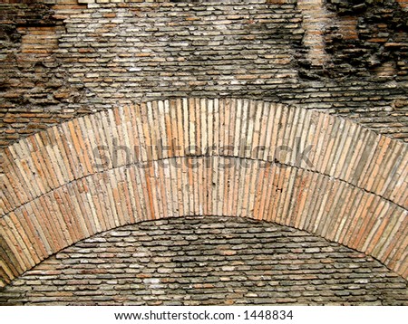 Old brick wall and arch. Interesting shapes on an old brick wall with an arch. Rome architecture.