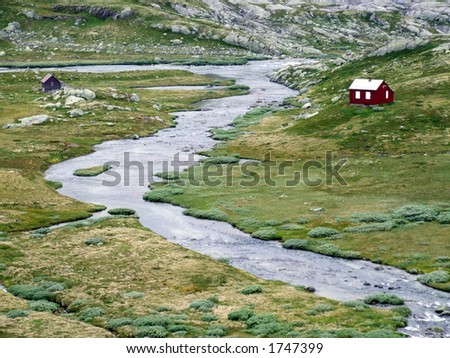 River and small houses in Norway. Lonely houses by the river in Norway.