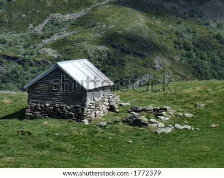 Old wooden cottage in mountains. Small wooden shed, typical for 