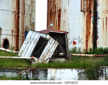 Old huge tanks in rust. Bankrupt industry left abandoned.