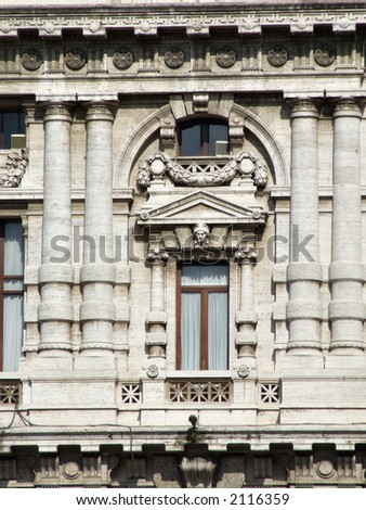Beautiful landmark in Rome. Old palace window with ornaments around it.