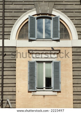 Old architecture in a mediterranean city. Windows in Rome.