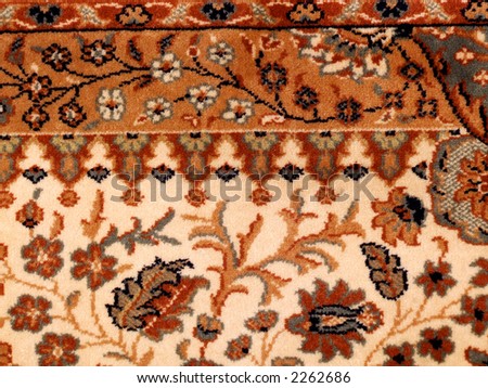 Ornamented rug. Carpet background with floral patterns.
