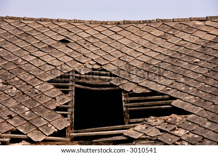 Old collapsed roof on a house. Polish countryside.