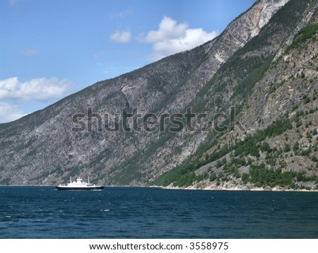 Passenger transportation in Norway - white ferry on the fjord.
