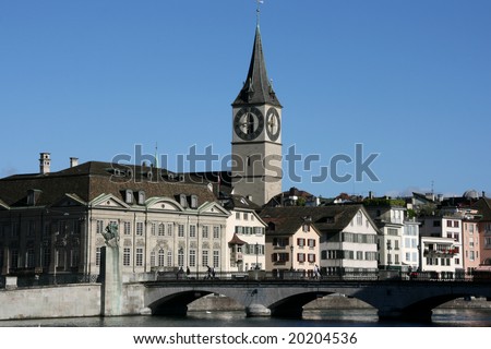 Zurich cityscape. St. Peter\'s Church tower with world\'s largest church clock face. Swiss city. Limmat river connecting with Lake Zurich.