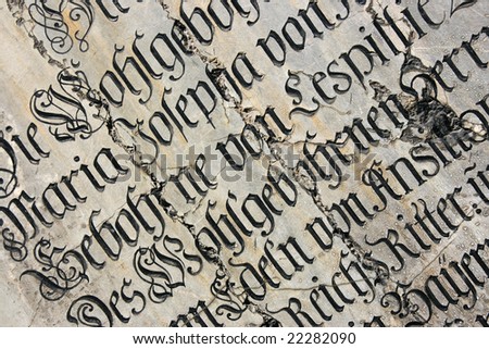 Vintage gothic script on a tomb. Mariendom church wall in Munich, Germany.