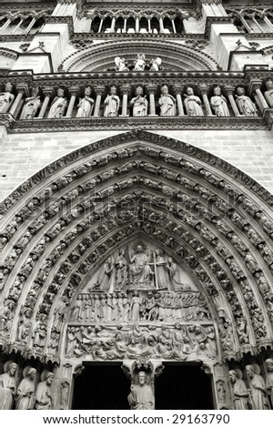 Decoration above the door of Notre Dame cathedral in Paris, France. Black and white.