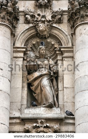 Allegory of cannon law - religious legal regulations of Roman Catholic church. Detail of the facade - University of Valladolid, Spain.