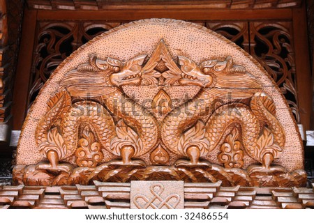 Oriental decorations at Nepalese Pagoda in Brisbane, Australia - wooden dragons