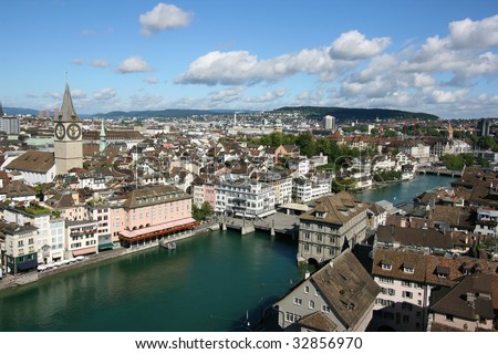 Zurich cityscape. St. Peter's Church tower with world's largest church clock face. Swiss city. Aerial view.