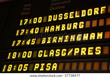 Departure board at an airport in Spain. Flights to Dusseldorf, Hamburg, Birmingham, Glasgow and Pisa.