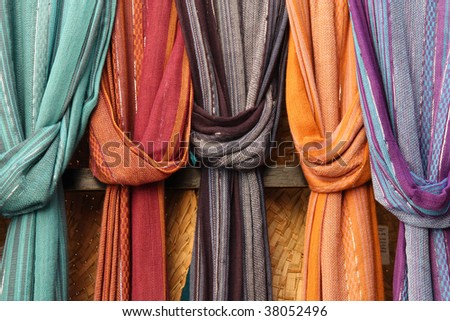 Colorful shawls or scarfes in a market stall. Shopping for fashion accessories.