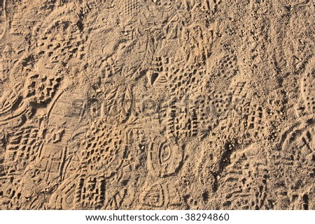 Shoe prints in loose sand. Dry soil shoeprints.