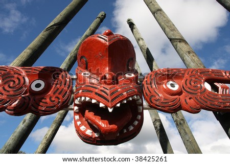 Maori red carving - face carved in the wood. Rotorua, New Zealand.
