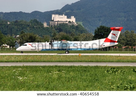 SALZBURG - AUGUST 6: Bombardier Dash 8 aircraft operated by Austrian Arrows at Salzburg International Airport on August 6, 2008 in Salzburg, Austria. Dash 8 is the most produced turboprop aircraft currently in operation.