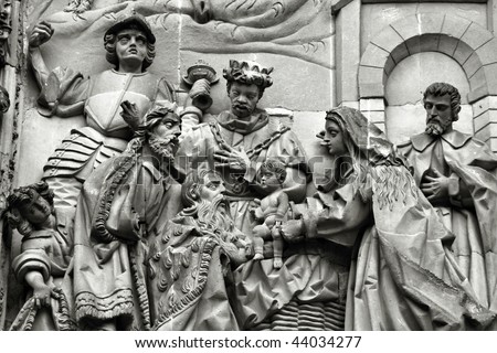 Three wise men or three kings visit the newborn Jesus Christ. They bear gifts of gold, frankincense, and myrrh. Sculpture above the Puerta del Nacimiento of Salamanca Cathedral.