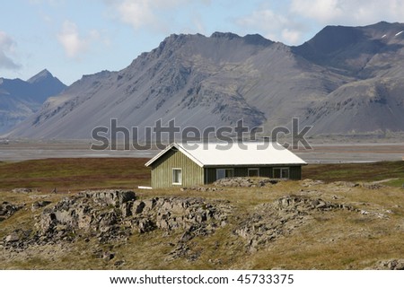 Landscape in Lonsoraefi region in Iceland. Small wooden home.