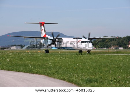 SALZBURG - AUGUST 6: Bombardier Dash 8 aircraft operated by Austrian Arrows on August 6, 2008 at Salzburg International Airport. Dash 8 is the most produced turboprop aircraft currently in operation.