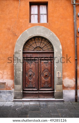 Pisa, Tuscany, Italy. Old Mediterranean architecture - decorative wooden door.