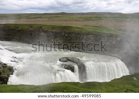 Famous waterfall - Gullfoss in Icelandic area called Golden Circle. Rainbow on river Hvita.