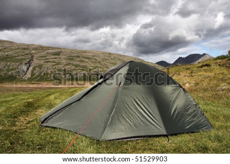 Tent in Lonsoraefi - desolate hiking area in Iceland. Summer camping. Stormclouds - overcast sky.