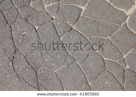 Damaged road. Background abstract of asphalt surface in bad condition - cracked tarmac.
